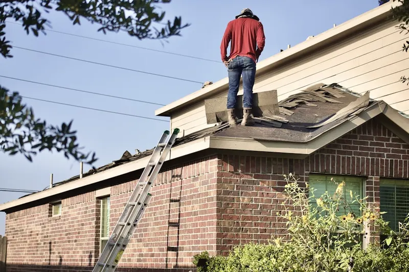 Professional roofer working on a residential roof in Estes Park